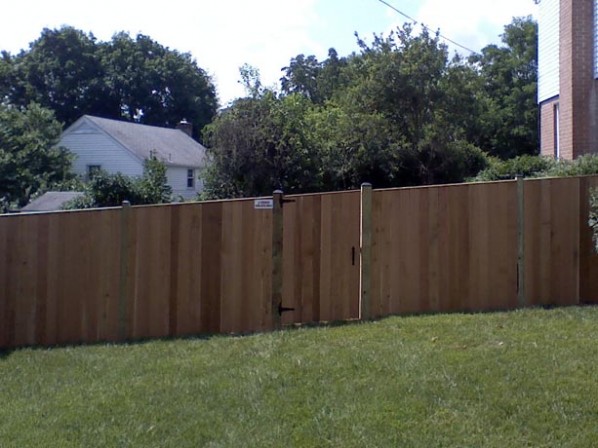 board and batten fence built on a sloped yard