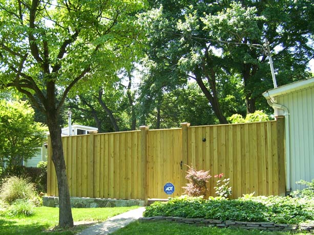 Board and batton fence with flat top